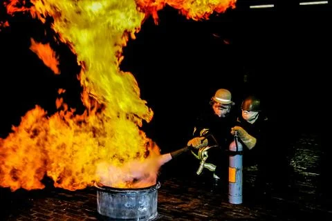 Firefighters training for fire fighting. Stock Photos