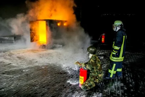 Firefighters training for fire fighting. Stock Photos