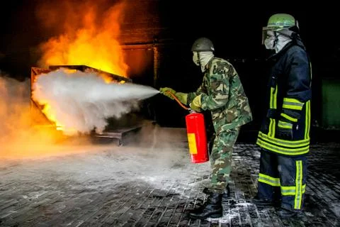 Firefighters training for fire fighting. Stock Photos