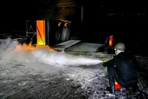 Firefighters training for fire fighting. Stock Photos