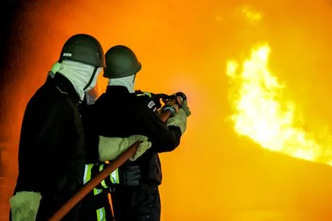 Firefighters training for fire fighting. Stock Photos