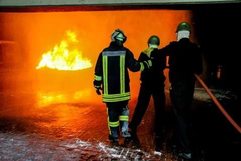 Firefighters training for fire fighting. Stock Photos