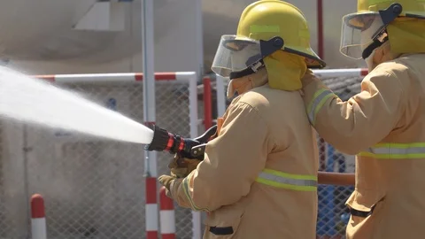 Firefighters training, foreground is drop of water springer Stock Footage 116257813