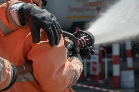 Firefighters training, foreground is drop of water springer, Selective focus. Stock Photos