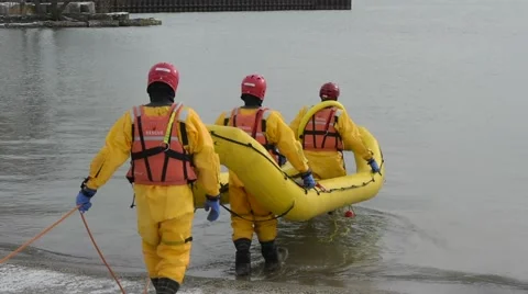 Firefighters Training in Ice Suit Launch Boat into Lake Stock Footage 60266217