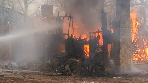 Firefighters trying to control house fire Video stock 73430138