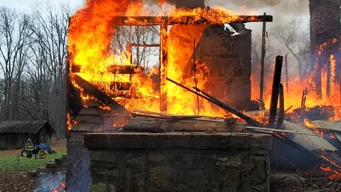 Firefighters trying to control house fire Stock Footage 73432394