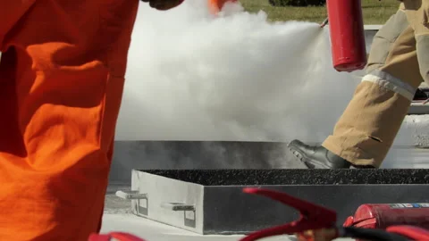 Firefighters Using Extinguisher on Outdoor Fire Stock Footage 322029819