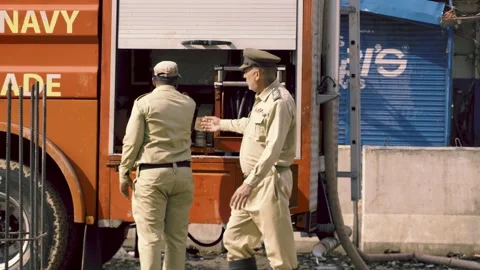 Firefighters using high-pressure water hoses and cranes to douse flames on the Stock Footage 331979697