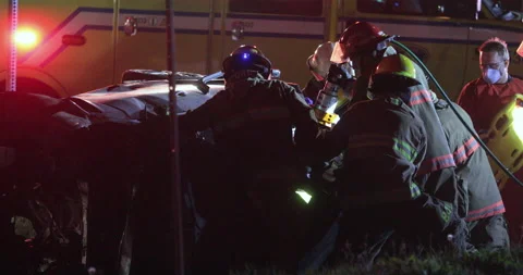 Firefighters using jaws of life Stock Footage 135425854