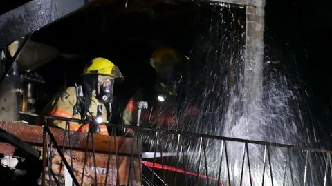 Firefighters watering completly burned structure Stock Footage 119947009