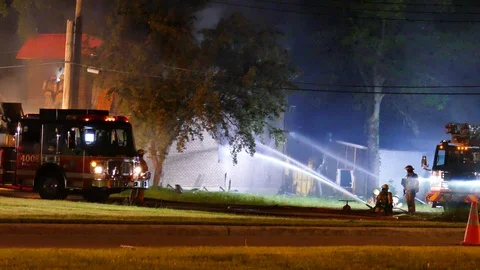 Firefighters watering house at fire Stock Footage 114766095