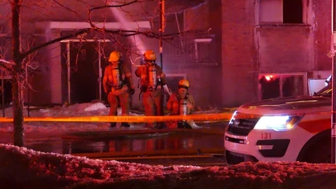 Firefighters watering structure and chief analyzing the situation Stock Footage 105277150