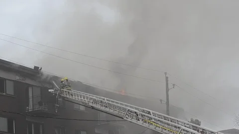 Firefighters work on a building in flames Stock Footage 106160449