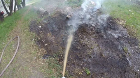 Firefighters work. Extinguishing a small fire on the ground. Stock Footage 63818839