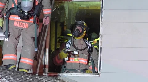 Firefighters Work Inside Home Through Window Stock Footage 61805197