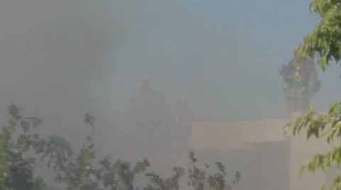 Firefighters at Work from a roof while smoke fills the air Video stock 10793305