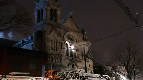 Firefighters working on the front of a church fire Video stock 105352985