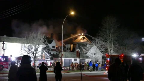 Firefighters working hard at massive structure fire Stock Footage 139657528