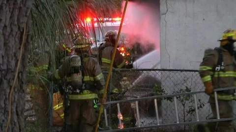 Firefighters working a house fire Stock Footage 759261