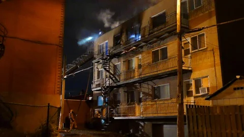 Firefighters working on structure fire Stock Footage 120106573
