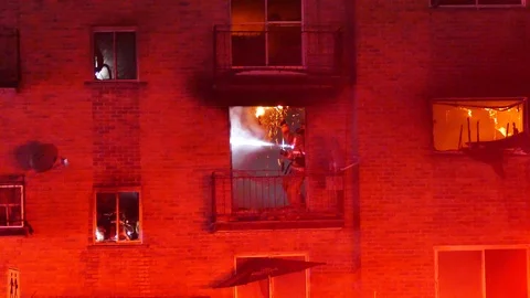 Firefighters working on structure with smoke and flames Stock Footage 104300261