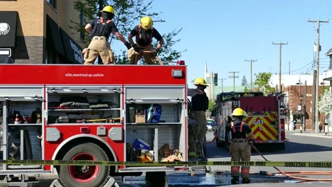 Firefighters working on the top of a firepump Stock Footage 139664493