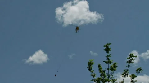 Firefighting Helicopter with Drop Bucket Approaching River Stock Footage 8561477