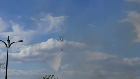 Firefighting helicopter drops water on a fire in the suburbs of Valencia, Spain Stock Footage 89038431