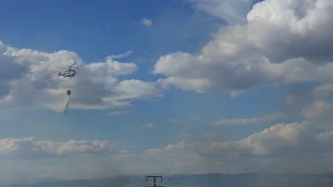 Firefighting Helicopter Drops Water on a Wildfire in Valencia, Spain Stock Footage 90487364