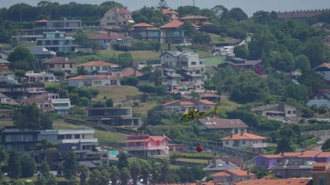 Firefighting helicopter flying low over houses Stock-Footage 319869204
