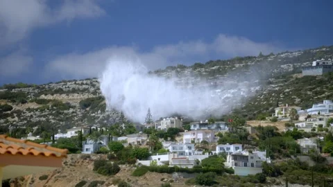 A firefighting plane extinguishes a fire in a mountain village Stock Footage 280850895