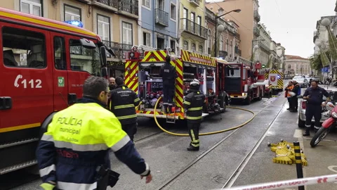 Firefighting Team Managing Emergency Scene in Urban Neighborhood Stock Footage 295149050