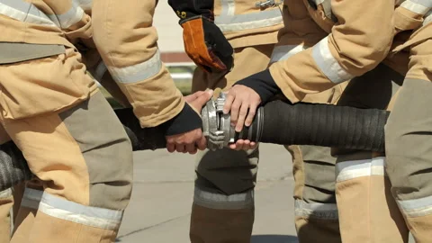 Firefighting Team Securing Heavy Water Hose Stock Footage 322029828