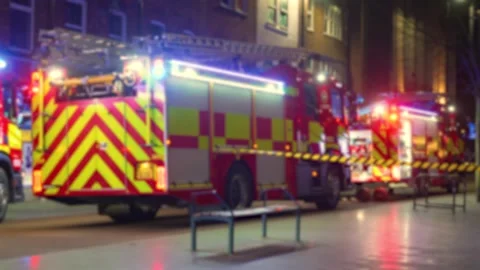 Firefighting vehicles blocking night street during active emergency with Stock Footage 326676143