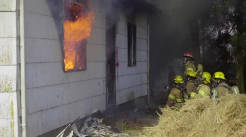 Firefights wait outside burning house Stock Footage 61168593
