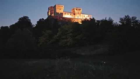 Fireflies Below Illuminated Castello di Torrechiara at Dusk Stock Footage 344584498