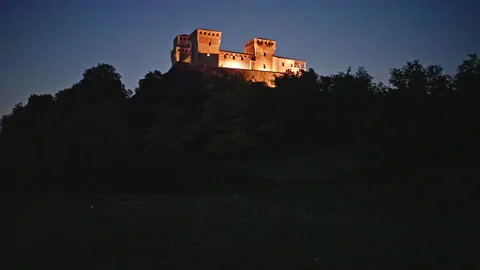 Fireflies Flicker Below Castello di Torrechiara at Blue Hour Stock Footage 344589720
