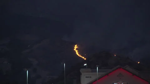 Firehawk helicopter makes beautiful dusk water drop on flames (Sand Fire) Video stock 65753169