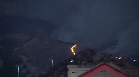 Firehawk helicopter makes beautiful dusk water drop on flames (Sand Fire) Video stock 65766314