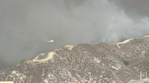 Firehawk helicopter makes low approach and water drop (Sand Fire) Stock Footage 65762467