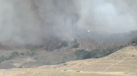Firehawk helicopter makes nice low approach and water drop (Sand Fire) Stock Footage 65762687