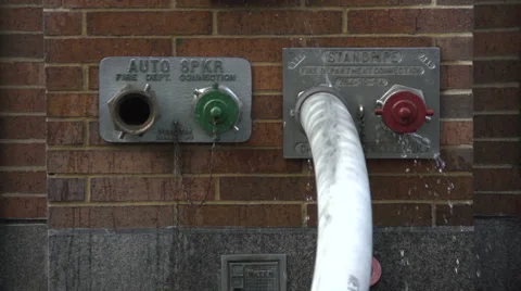 A firehose spraying water in slow motion Stock Footage 44115944