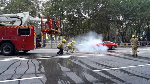 Fireman in Action, Car on Fire Stock Footage 78570937
