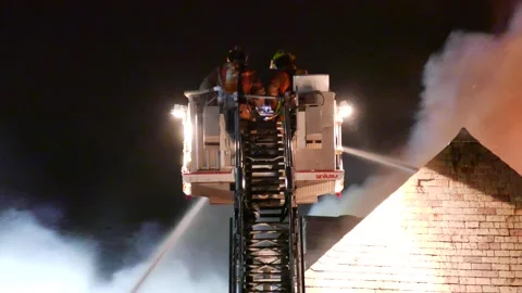 Fireman battling flames in platform Stock Footage 139657360