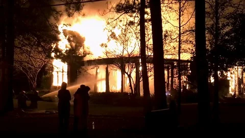 Fireman battling a residential home fire Stock Footage