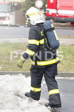 Fireman with breathing apparatus going into an action. Real fire scene. Czech Stock Photos