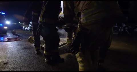 Fireman Carrying Someone From Terrible Car Accident Stock Footage 143546331