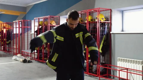 Fireman changing clothes in fire departm... | Stock Video | Pond5