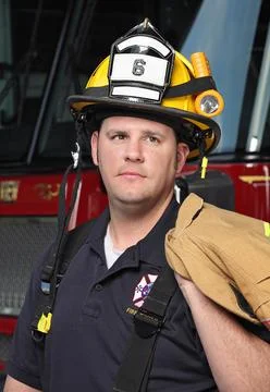 Fireman close-up in front of fire engine Stock Photos